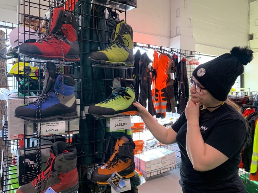 Step 1 Boot selection: an arborist in an store looking for to get a new chainsaw boots